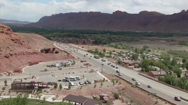 Aerial: Moab, Utah. Flying over the main road leading into the town. 