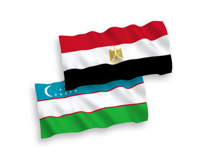 National vector fabric wave flags of Uzbekistan and Egypt isolated on white background. 1 to 2 proportion.