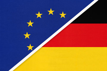 European Union or EU vs Germany national flag from textile. Symbol of the Council of Europe association.