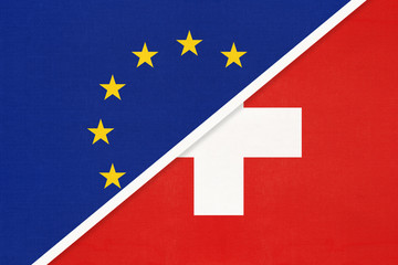 European Union or EU vs Switzerland national flag from textile. Symbol of the Council of Europe association.