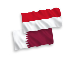 National vector fabric wave flags of Indonesia and Qatar isolated on white background. 1 to 2 proportion.