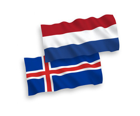National vector fabric wave flags of Iceland and Netherlands isolated on white background. 1 to 2 proportion.