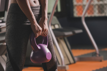 Sport woman fit kettlebell training in gym room. sport relax and healthy life in indoor or sport complex to add strength to the lungs.