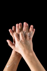 Kid showing how to wash hands to prevent virus desease, on black background