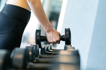 Fototapeta na wymiar Young women exercise dumbbells