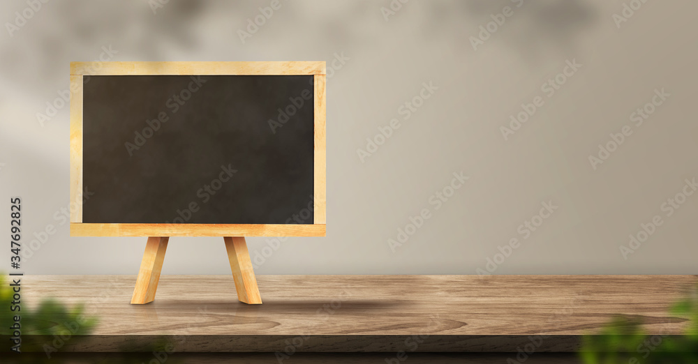 Poster menu blackboard on wood table backgorund with sunlight window create leaf shadow on wall with blur i