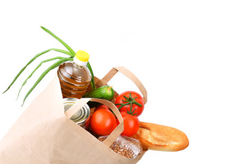 Paper bag with food supplies for the period of quarantine isolation on a white background. Copyspace.