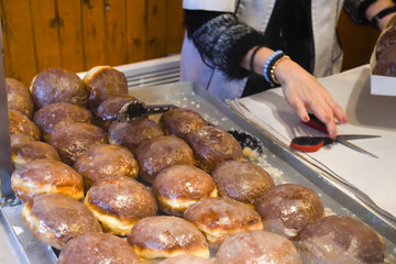 A lot of small round deep fried donuts, simple, no syrup or dipping sauce. Large bowl of donuts