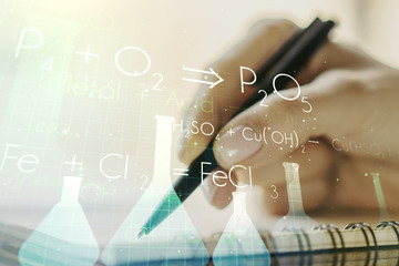 Creative chemistry hologram with man hand writing in notepad on background, pharmaceutical research concept. Multiexposure