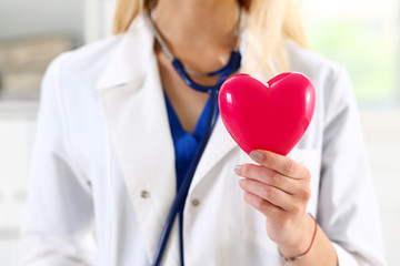 Female medicine doctor hands holding red heart