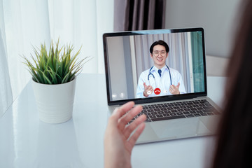 Fototapeta na wymiar Asian doctor video conference with woman patient care discussing and consultant for medical coronavirus video call user interface healthcare online service remotely talking when quarantine at home.