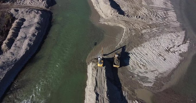 Working together aerial Water escavators. Arno river near Sieci town, Pontassieve, to avoid another Florence disaster flood afer latest November rainy long season. Sunny day Winter, Tuscany. Italy