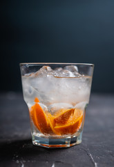 Old fashioned beverage with orange slices on rustic background. Selective focus. Shallow depth of field.
