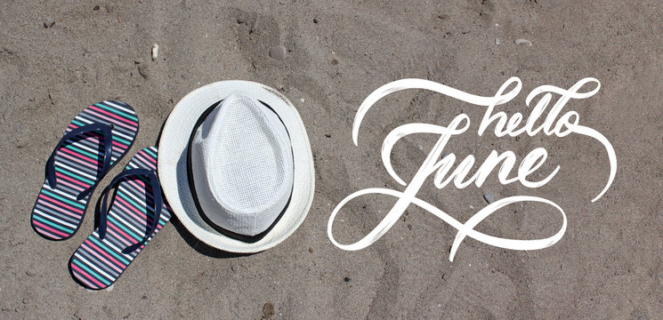 Hello June hand lettering card. Hand drawn script and sand on the beach on background. Seasons calendar months.