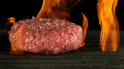 Raw beef burger cutlet on grill