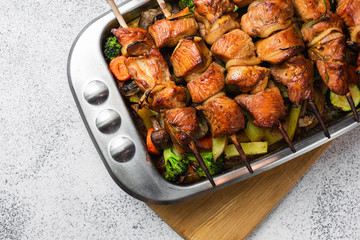 Appetizing, juicy turkey skewers on wooden skewers. Home cooking. Family dinner option. Homemade food.