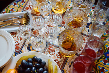 Sparkling glassware and fruits on dinner table in restaurant, copy space. Crystal glasses ready for celebration. Wineglasses at luxury wedding reception