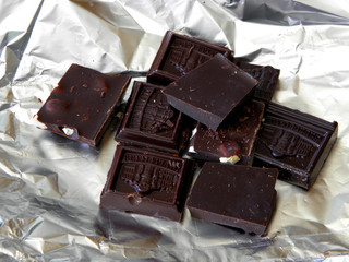 Dark natural Chocolate lies on the foil