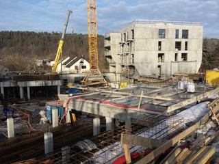 Apartment buildings construction site with cranes