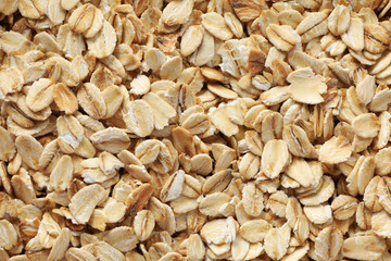 Oatmeal flakes texture on whole background, close up