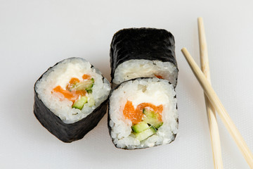 Set of eel sushi rolls with chopsticks.