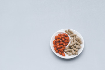 Two types of pills on a gray background