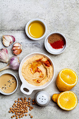 Flat lay of hummus bowl and ingredients for making hummus, top view. Vegan food concept.
