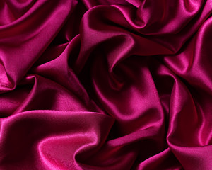 chic red  satin material in a crease.