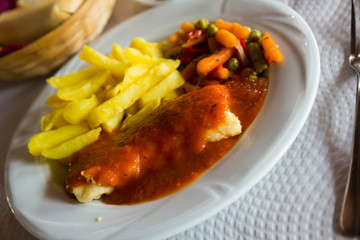 Cod fillet cooked in tomato sauce