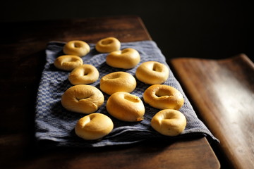 Fresh Homemade Bagels on a Kitchen Tower on a dark wooden table