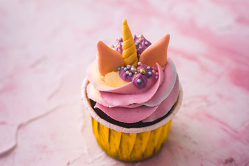 Rainbow unicorn cupcake in a yellow cup. A feast for a little princess.
