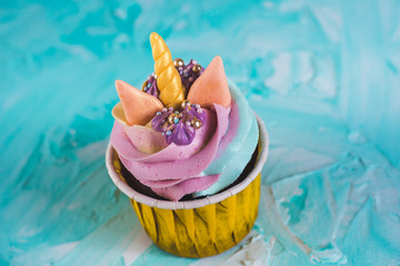 Rainbow unicorn cupcake in a yellow cup. A feast for a little princess.