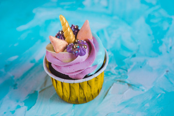 Rainbow unicorn cupcake in a yellow cup. A feast for a little princess.
