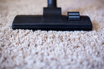 vacuuming a carpet. vacuum cleaner brush on the carpet