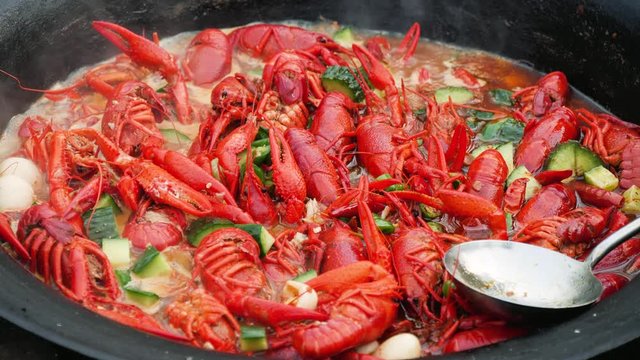 Chef cooking Spicy crayfish crawfish in wok. food Chinese food crustaceans Red crayfish
