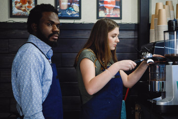 Barista girl with a coffee machine.