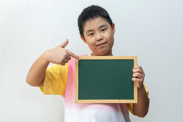 Asian boy holding empty board. Concept of education