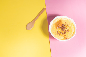 delicious custard in yellow and pink background