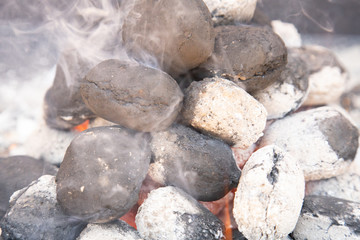 metal barbecue with charcoal burning