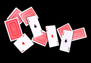 Flying playing cards for poker game on black background.