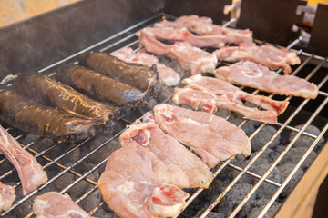 metallic charcoal barbecue with delicious meat