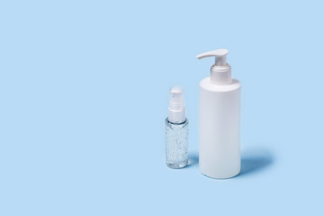 Blue background with medical supplies. Front view with a bottle of antiseptic soap and a hand sanitizer.