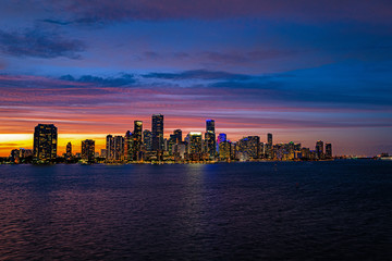 Fototapeta na wymiar Miami Florida, skyline of downtown night colorful skyscraper buildings. Miami city, Florida skyline panorama at dusk with urban skyscrapers. Business district Miami.