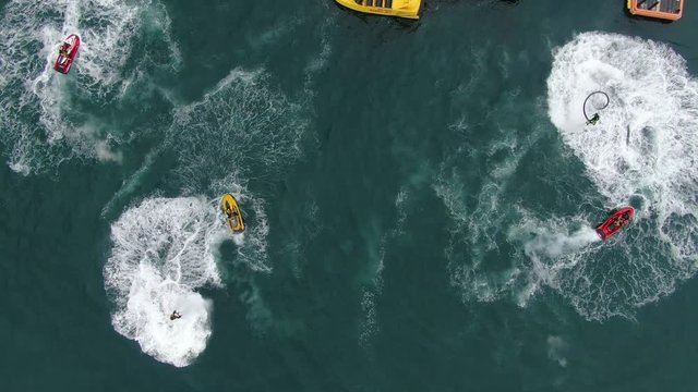 Team demonstrating a flyboard on the sea.