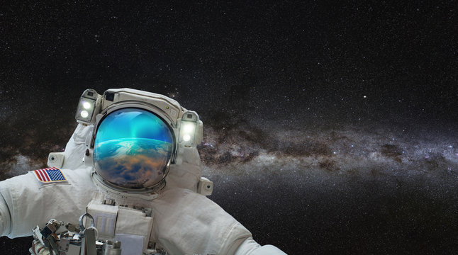 An astronaut watching the Aurora Borealis in space "Elements of this image furnished by NASA"