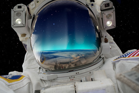 An astronaut watching the Aurora Borealis in space "Elements of this image furnished by NASA"