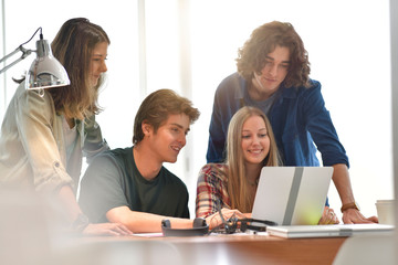 Group of students using laptop computer