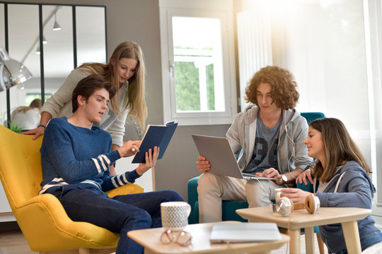 Group of flatmates having fun at home