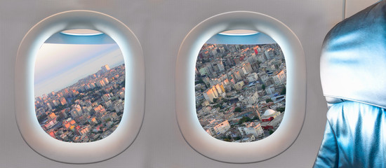 City landscape as seen through window of an commerical passenger airplane