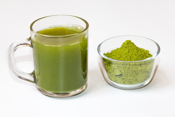 Green tea matcha in a glass bowl on a white background close-up. Useful tea matcha macro. Matcha drink in a Cup.